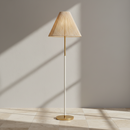 A modern floor lamp with a tapered beige pleated shade, a slim white central stem, and a brushed gold base and upper section, shown against a plain white background.